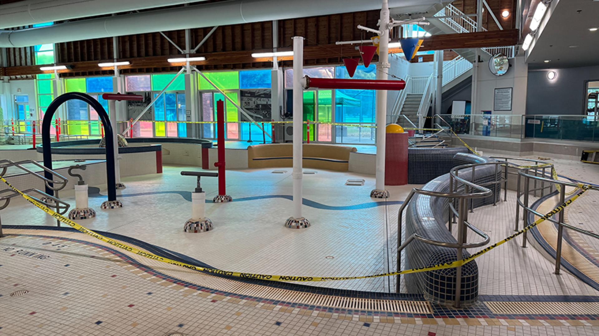 Empty leisure pool's spray feature and water blasters