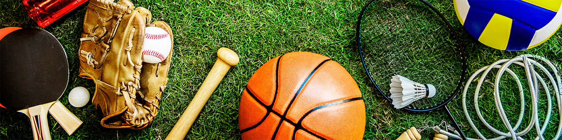 All different types of sports equipment set on a turn field