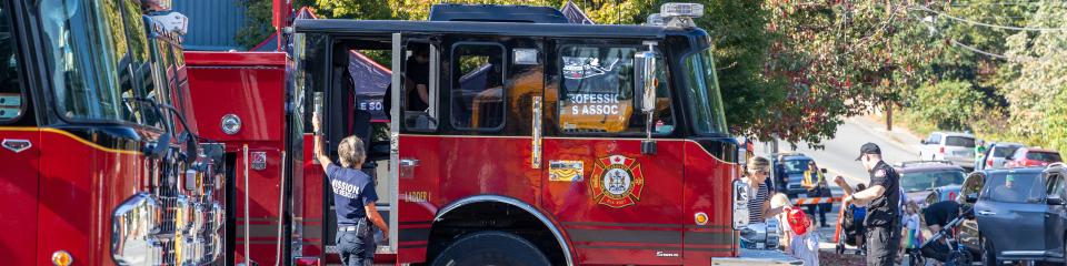 firefighter getting into fire truck