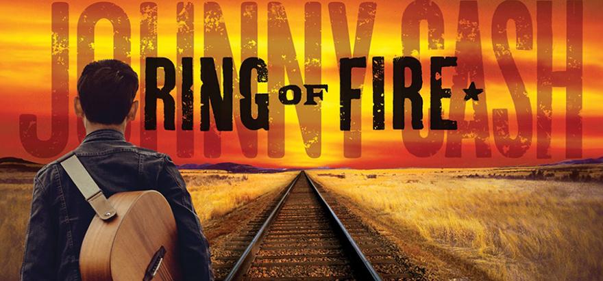 poster of johnny cash walking down train track with guitar on his back