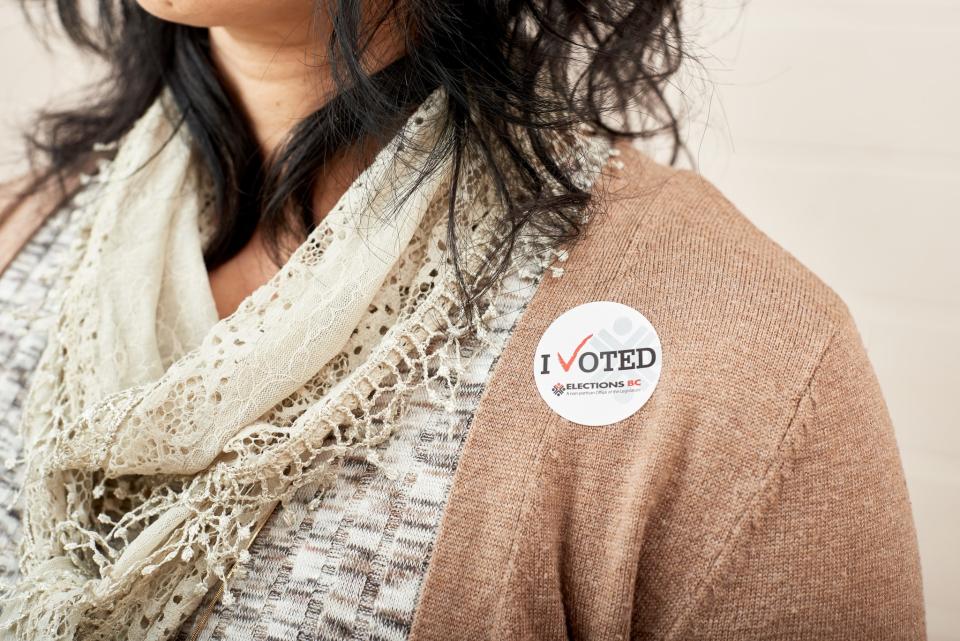Person with a sticker that says "I Voted" on her sweater