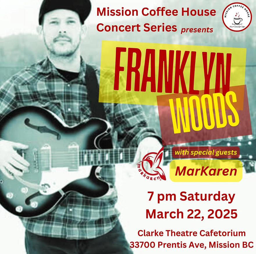 Franklyn Woods holding a guitar smiling