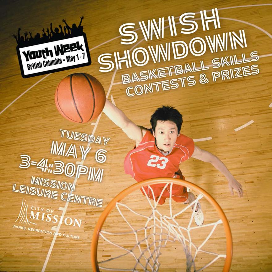 Young man looking up at basketball hoop with basketball in hand about to make a slam dunk