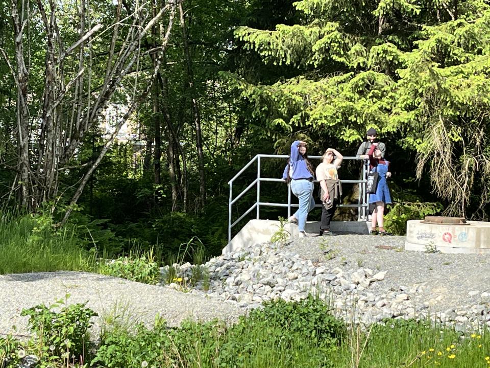 Image of students on concrete culvert on Gaudin Creek Trail
