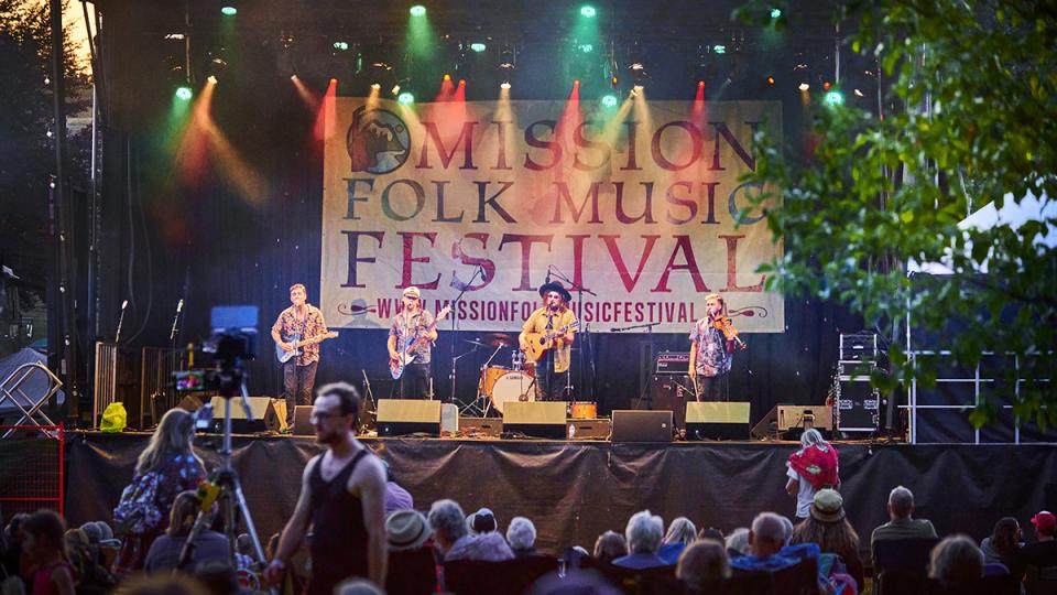 Instrumental band performing on folkfest main stage in front of big crowd